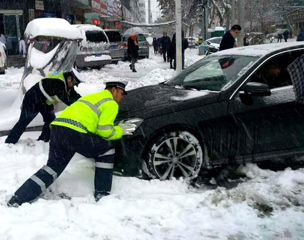 駐馬店迎今年首場(chǎng)雪 交警在風(fēng)雪中站成“雪警”（圖）